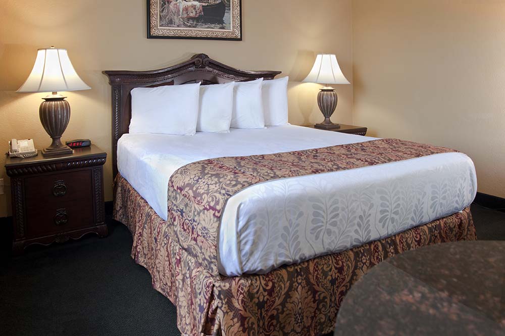 Queen size bed at Branson Stone Castle Hotel & Conference Center